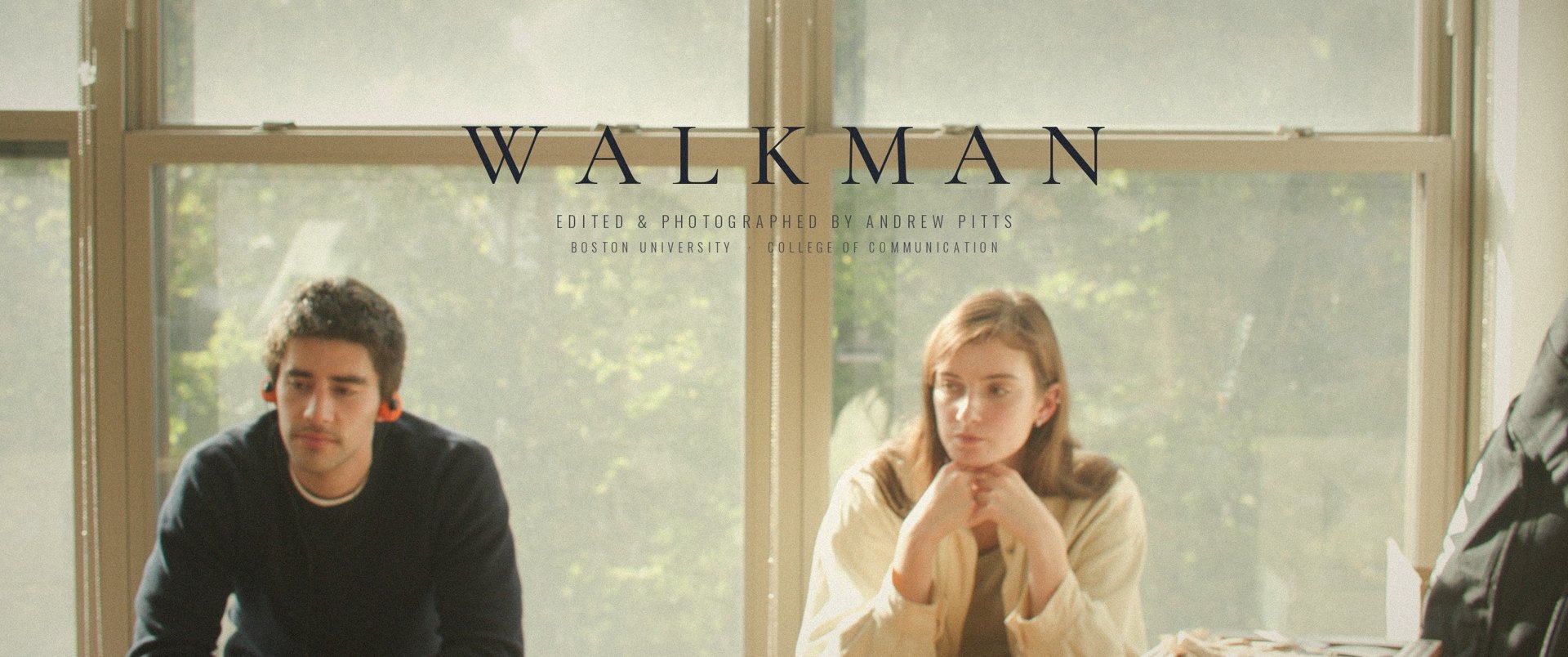 Title still from Walkman: two people sit in front of tall sunlit windows, he wears orange headphones